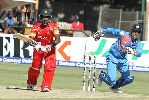 Zimbabwe's Elton Chigumbura, left, plays a shot as Indian wicketkeeper MS Dhoni fields. | AP