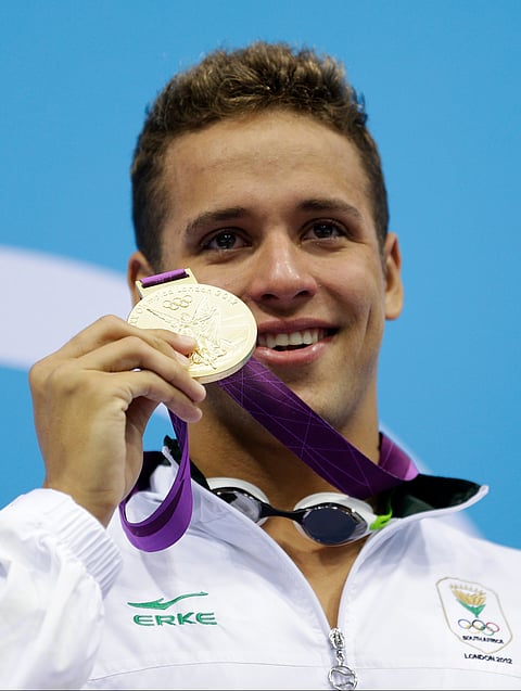 In this Tuesday July 31, 2012 file photo, South Africa's Chad le Clos poses with his gold medal for the men's 200-meter butterfly swimming final at the Aquatics Centre in the Olympic Park during the 2012 Summer Olympics in London.