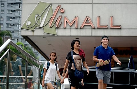 Shoppers walk in front of "Ali-Mall" | AFP