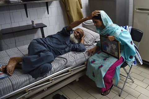 This file photo taken on October 15, 2015 shows Indian woman, Geeta being blessed byAbdul Sattar Edhi, the chairman of Edhi Foundation in Karachi. Abdul Sattar Edhi, died on July 8, 2016, at the age of 92, his son confirmed as tributes swiftly poured in f