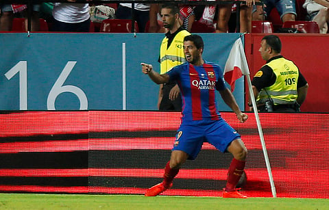 Barcelona's Luis Suarez celebrates after scoring the first goal against Sevilla, during the Spanish Super Cup first-leg soccer match at Ramon Sanchez-Pizjuan stadium in Seville, Spain. | AP