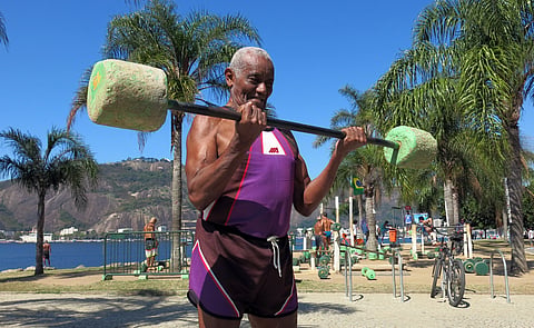 Jose Rebamar, 75, lifts weights at an outside gym in Rio de Janeiro, Brazil, Sunday, Aug. 14, 2016. With near daily sunshine and warm weather all year, the former Brazilian Navy sailor says there is no excuse to ever slow down. | AP
