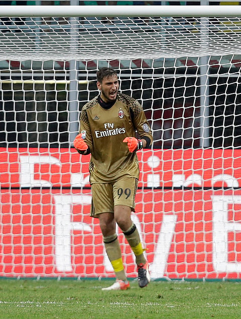 AC Milan goalkeeper Gianluigi Donnarumma celebrates after saving a penalty during the Serie A soccer match between AC Milan and Torino at the San Siro stadium in Milan, Italy, Sunday, Aug. 21, 2016. | AP