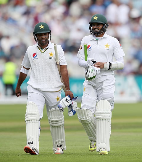 Pakistan batsman Sami Aslam, left, and Pakistan batsman Azhar Ali walk off at lunch during day two of the 3rd Test Match against England at Edgbaston, cricket ground in Birmingham England. (AP)