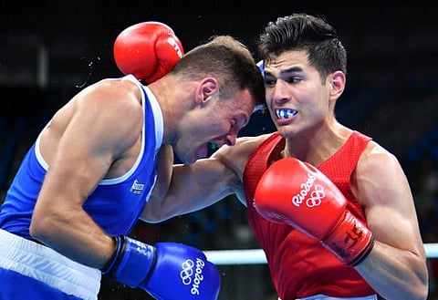 Italy's Carmine Tommasone (L) fights Mexico's Lindolfo Delgado during the Men's Light (60kg) match at the Rio 2016 Olympic Games at the Riocentro - Pavilion 6 in Rio de Janeiro on August 6, 2016. | AFP