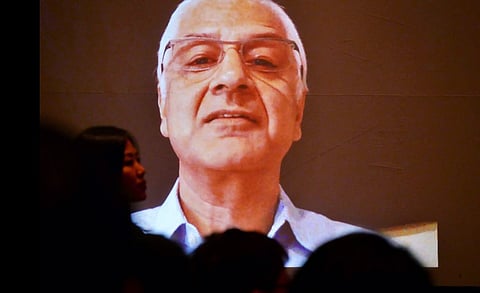 Kunda Dixit, Nepali journalist and publisher, addresses attendees through video conferencing from an undisclosed location during a gathering of more than 350 journalists from 50 countries at a conference in Kathmandu, Nepal. | AP