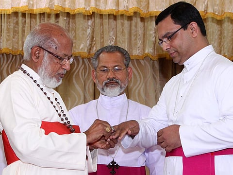 Syro Malabar Church head Mar George Cardinal Alencherry presenting bishop-elect Fr Thomas Tharayil with the insignia of episcopacy. Archbishop of Changanassery Mar Joseph Perumthottam looks on, at St Thomas Mount in Kochi | Albin mathew