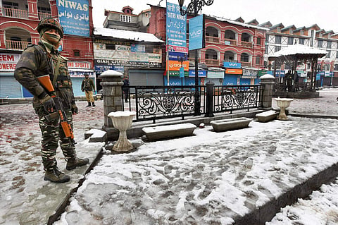 A Security jawan standing guard during a strike call given by separatists on the 68th Republic Day at Lal Chowk | PTI