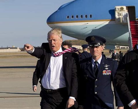 President Donald Trump walks on the tarmac as he waves to the crowd upon his arrival at Andrews Air Force Base, Md., Thursday, Jan. 26, 2017. | AP