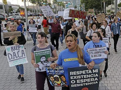 Protesters chant slogans against President Donald Trump's executive order on immigration Thursday, Jan. 26, 2017, in downtown Miami. | AP
