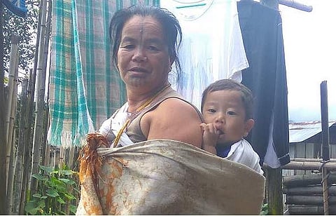 Narang Yamyang, the last woman from Apatani tribe to get a facial tattoo, with her grandson at their residence in Hong village in Ziro Valley in Lower Subansiri district of Arunachal Pradesh on Sunday. | Aishik Chanda