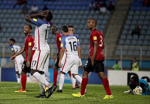 United States' Jozy Altidore, left, reacts after missing a chance to score during a 2018 World Cup qualifying soccer match against Trinidad and Tobago in Couva, Trinidad, Tuesday, Oct. 10, 2017. | AP