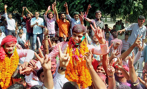 Newly elected Allahabad University Students Union President Avanish Kumar Yadav center along with suppoters celebrate after Samajwadi Chhatra Sabha won four out of the five posts in Allahabad on Sunday. (PTI)