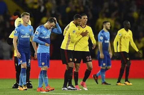 Arsenal's German midfielder Mesut Ozil (2L) reacts at the final whistle as Watford's English striker Troy Deeney (CL) and Watford's German-born Greek midfielder José Holebas (CR) during the English Premier League football match between Watford and Arsenal