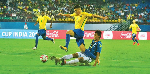Brazil’s Paulinho skips past a challenge from Honduras’ Gustavo Vallecillo in their FIFA U-17 World Cup pre-quarterfinal at the Jawaharlal Nehru International Stadium in Kochi on Wednesday. Brazil won 3-0 to enter the quarterfinal | K Shijith