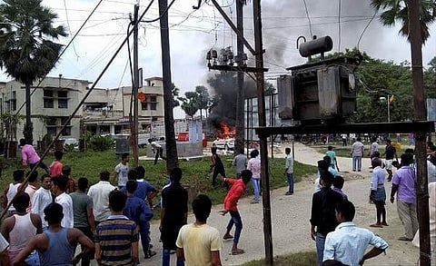 Smoke rises from burning police vehicles in Tajjpur police station campus after it was torched by an angry protesters at Tajpur in Samastipur district. (Photo | PTI)