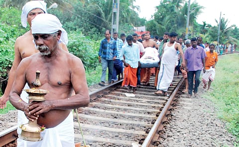 The funeral cortege of a man progresses with mourners carrying the body of the deceased down the rail tracks at Kammattipaadam near Ernakulam South Station | k shijith