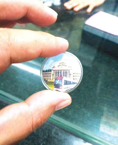 Passenger holds up a new token at Metro Station