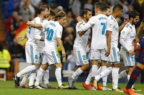 Real Madrid's Sergio Ramos, left, celebrates with teammates after scoring the opening goal against Eibar during the Spanish La Liga match. | AP
