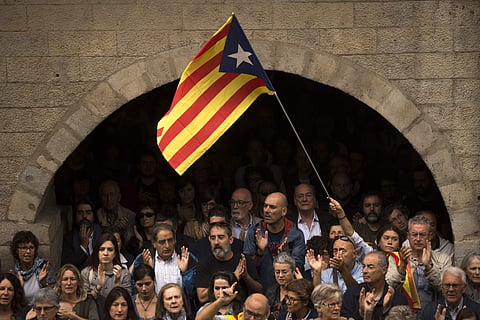 Catalan independence supporters, one waving an 'estelada', or Catalonia independence flag. (Photo | AP)