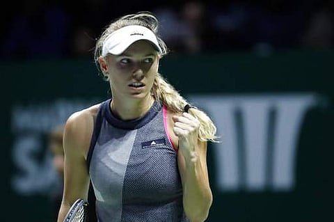 Caroline Wozniacki of Denmark celebrates after scoring a point against Venus Williams of the United States during their singles final match at the WTA tennis tournament in Singapore.|AP