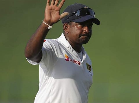 Sri Lanka's bowler Rangana Herath waves after they beat Pakistan during their fifth day at First Test cricket match in Abu Dhabi, United Arab Emirates, Monday, Oct. 2, 2017. | AP