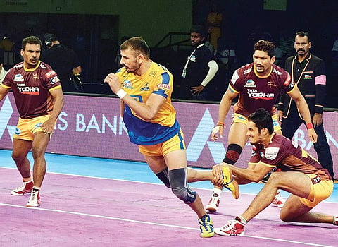 Tamil Thalaiva’s Ajay Thakur (centre) in action against UP Yoddha. | Express Photo Service