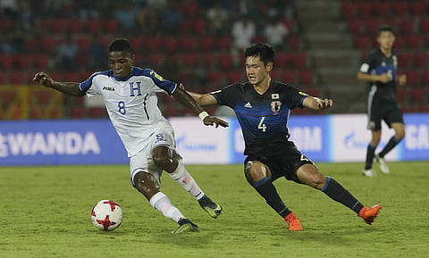 Japanese player Takefusa Kubo, 7, duels for the ball during the FIFA U-17 World Cup match against Honduras in Gauhati, India, Sunday, Oct.8 , 2017. | AP