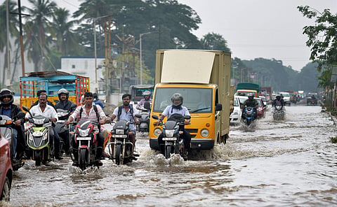 Vehicles on a flooded road in Gujarat after heavy rains