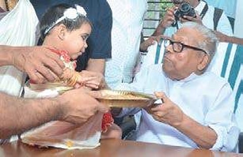 Administration Reforms Commission Chairman V S Achuthanandan initiating a child into the world of letters.