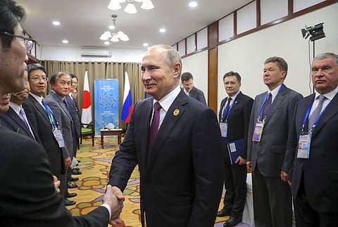 Russia's President Vladimir Putin, center, greets members of Japan's Prime Minister Shinzo Abe's delegation prior to the talks at the APEC Business Advisory Council | AP