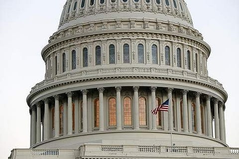 The American flag flies in front of the U.S. Capitol dome at sunset on Capitol Hill in Washington. (Photo |AP)