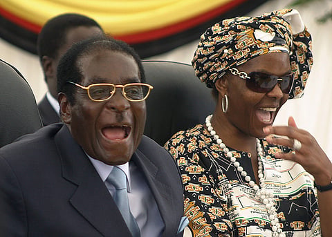 In this March 27, 2008 file photo Zimbabwean President Robert Mugabe, left, and his wife Grace, right, react during a visit to Harare hospital in Harare, Zimbabwe. (Photo | Associated Press)