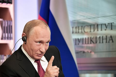 In this Monday, May 29, 2017 photo released by the Sputnik news agency, Russian President Vladimir Putin speaks during an interview in Paris, France. On Thursday, June 1, 2017, Putin told reporters, Russian hackers might “wake up, read about something goi