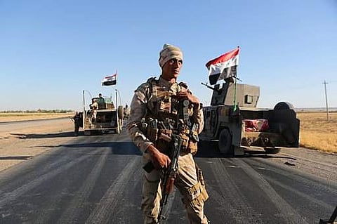 Iraqi security forces gather outside the Kurdish-held city of Altun Kupri on the outskirts of Irbil, Iraq.|AP