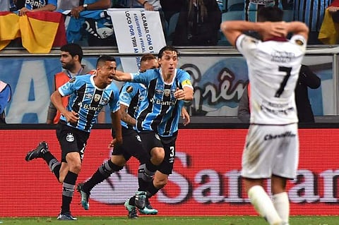 Cicero (L) of Brazil’s Gremio celebrates with teammates after scoring against Argentina's Lanus, during their Copa Libertadores 2017 first leg final match at Arena Gremio stadium. | AFP