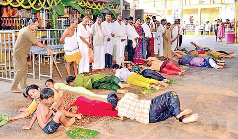 Hundreds of devotees participate at the ‘Ede snana ritual’ by rolling on the plantain leaves at Kukke Subrahmanya temple on Wednesday