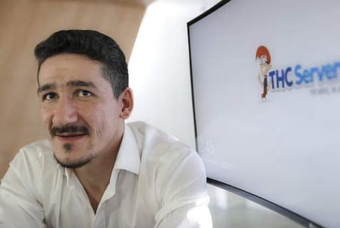 Catalin Florica, who launched THCServers.com in 2013, poses for a portrait during an interview at the company's headquarters, outside Craiova, southern Romania, Wednesday, Oct. 4, 2017. | AP