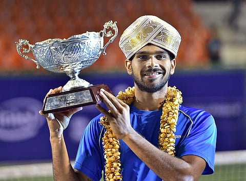 Sumit Nagal of India wears the mysore peta and hold the winner trophy after beating Jay Clarke of Great Britain during the final match of Bengaluru Open 2017 ATP Challenger at KSLTA in Bengaluru on Saturday. | PTI