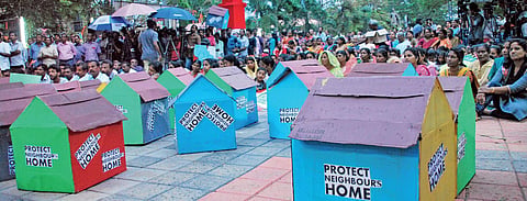 A file photo of the residents at Puthuvype who have been up in arms against the proposed IOC terminal, holding a protest meet at Rajendra Maidan with replica of houses, demanding the protection of their homes| K Shijith