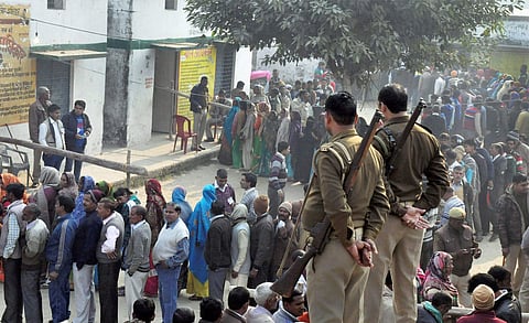 People wait in queues to cast their votes for civic polls in Moradabad on Wednesday. | PTI