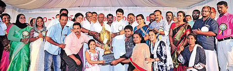 Power Minister M M Mani handing over the trophy for overall champion to the Aluva sub-district team