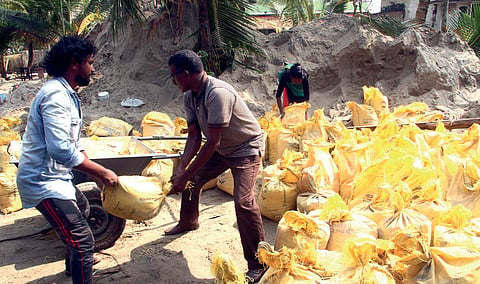 DYFI activists removing sand deposited by sea in the effect of cyclone Ockhi near Maruvakadu Velankanni Church in Kochi on Sunday |Melton Antony