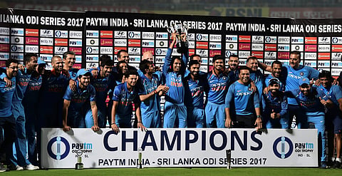 Indian cricket team poses with the trophy after winning the 3rd and final ODI match against Sri Lanka in Vizag on Sunday. (PTI)