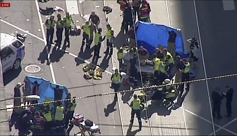 Emergency medical workers offer aid to victims struck by a vehicle | AP