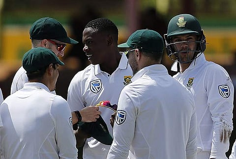 South Africa's bowler Kagiso Rabada (C) is congratulated by teammates after taking his 100th Test wicket. (Photo | AFP)