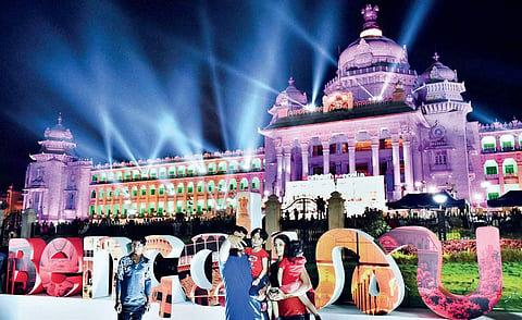 A family poses for a selfie in front of the decked-up Vidhana Soudha at Bengaluru Habba on Sunday | jithendra m