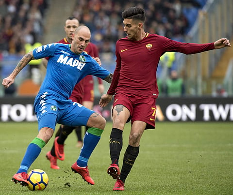 Sassuolo's Paolo Cannavaro (L) and Roma's Lorenzo Pellegrini vie for the ball | AP