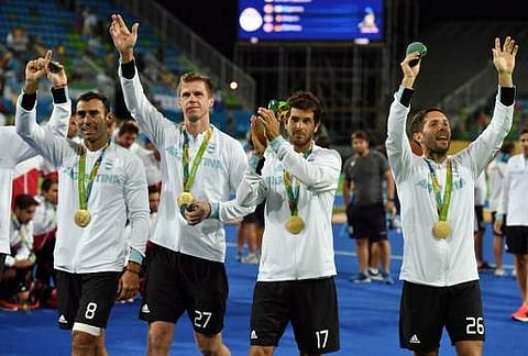 (From L) Argentina's Lucas Rey, Argentina's Lucas Rossi, Argentina's Juan Lopez and Argentina's Agustin Mazzilli celebrate with their gold medals during the men's field hockey medals ceremony of the Rio 2016 Olympics Games at the Olympic Hockey Centre in