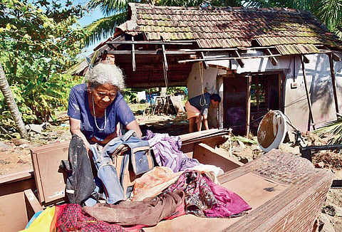 Kunjamma Joseph, 74, of Nayarambalam panchayat in Vellithanparambu beach on the Vypeen-Cherai stretch, going through her belongings while standing in front of her house which was destroyed in cyclone Ockhi. She returned after her stay at a relief camp on
